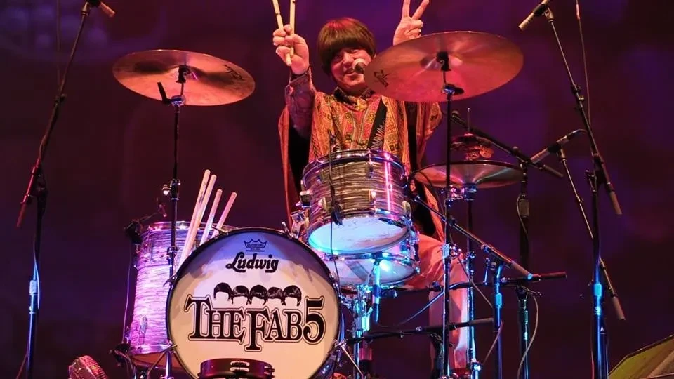 Fab 5 drummer on stage with Ludwig kit and The Fab 5 bass drum head