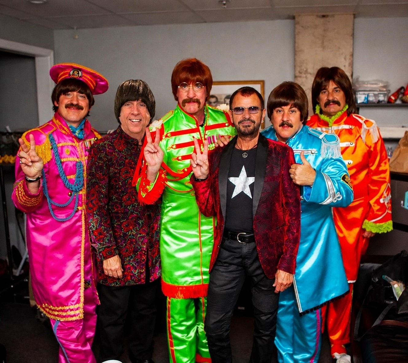 Fab 5 in Sgt. Pepper costumes performing with orchestra